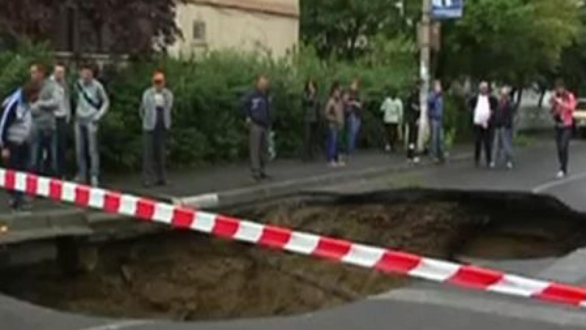 O groapă uriaşă s-a format în mijlocul străzii. Şoferii, la un pas de tragedie