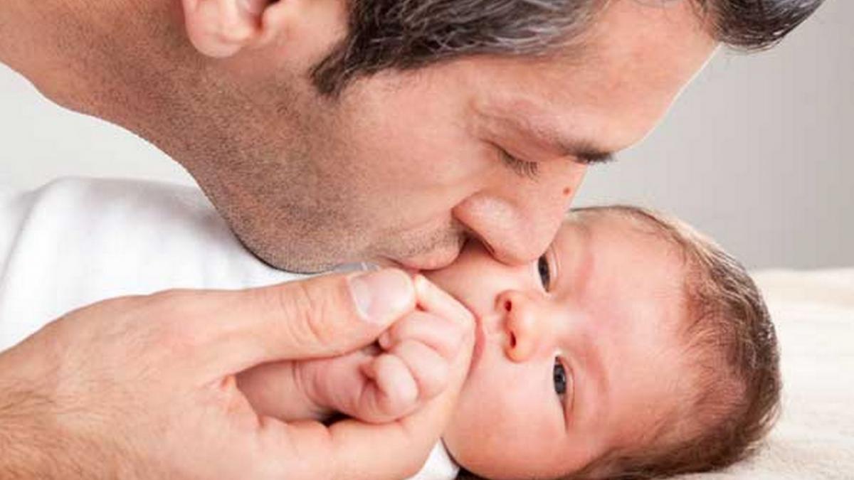 father-kissing-baby-boy-436169622.jpg