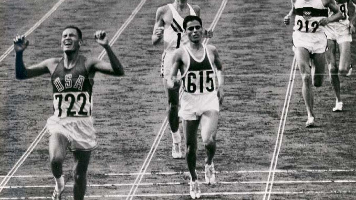 BillyMills_Crossing_Finish_Line_1964Olympics.jpg