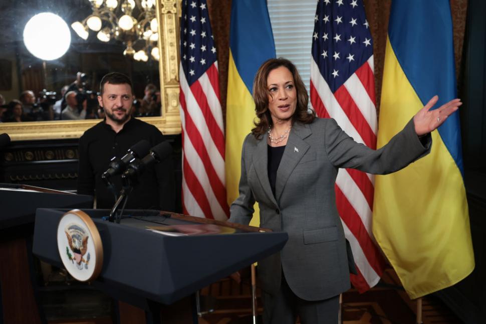 Kamala Harris gesticuleaza in timp ce Volodimir Zelenski priveste spre camera in timpul unei conferinte de presa.