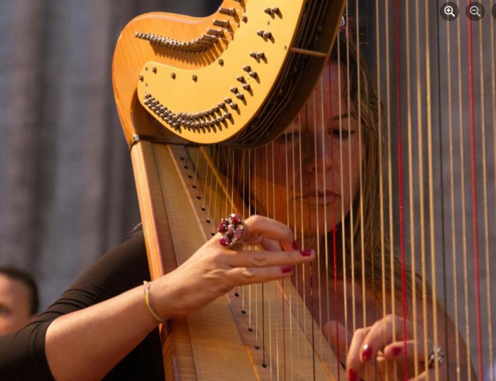 O femeie canta la harpa